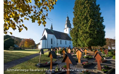 Die Kirche St. Peter und Paul mit Friedhof an einem Herbsttag in der Sonne