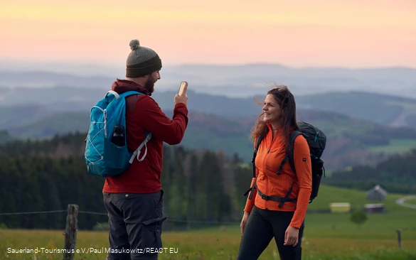 Ein Wanderer macht eine Handyaufnahme am Krutenberg in Medebach